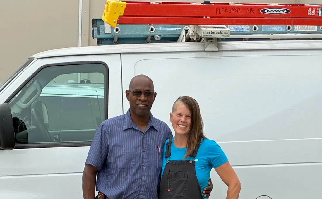 Two Pleasant Air Company technicians in front of the service van